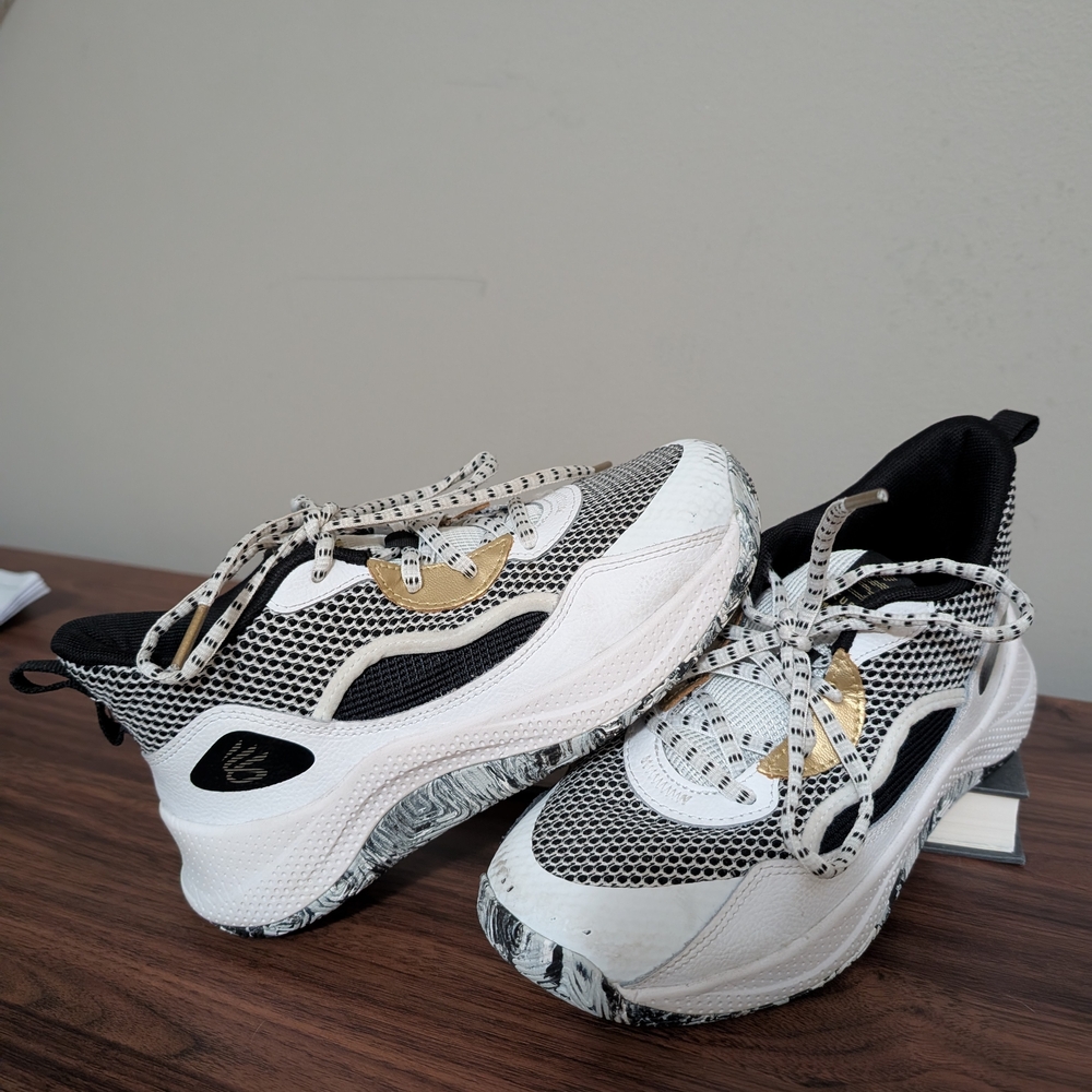 Under Armour Women's Sneakers in White, Black, and Gold